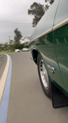 Green car turns left on Scarborough road