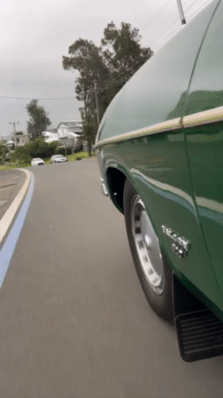 Green car turns left on Scarborough road