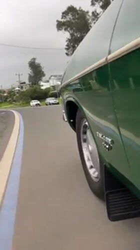 Green car turns left on Scarborough road