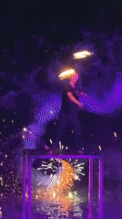 Fire dancer performs torch routine on Thai beach