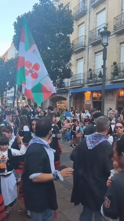 Basque flag flying high at a street celebration in Vitoria-Gasteiz
