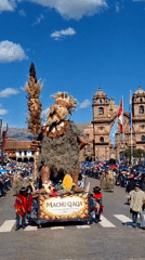 Elaborate nature-adorned parade float with crowned ceremonial figure