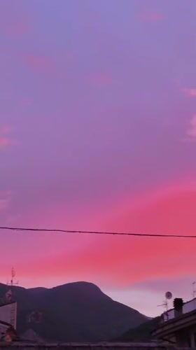 Fiery sunset over the mountains and rooftops of Campochiaro