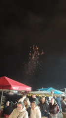 Fireworks display over waterfront dining area in Ponta Delgada