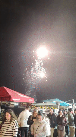 Fireworks display over waterfront dining area in Ponta Delgada