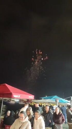 Fireworks display over waterfront dining area in Ponta Delgada