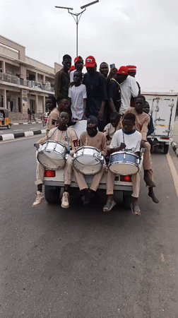 Street celebration with drums and vehicles in Tudun Wada