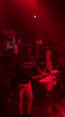Late-night club scene in Abuja, live drums and dancing