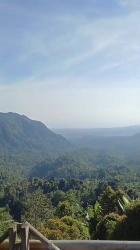 Woman visits scenic mountain viewpoint in Sawan, Indonesia
