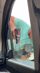 Man repairs car window and mirror in Meknes