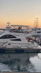 Sunset evening at Sochi Grand Marina, yachts and waterfront crowds