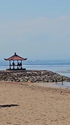 Relaxed morning at Sanur Beach, Bali's traditional coastline