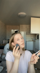 Woman applies makeup in Zubovo, Russia