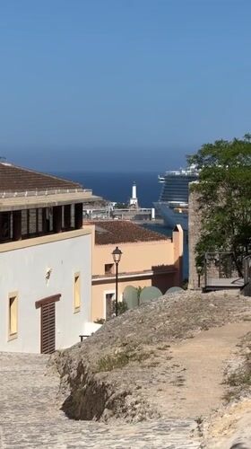 Mediterranean coastal town viewed from stone pathway in Spain