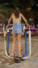 Woman exercises at beachfront outdoor gym in Da Nang