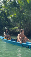 Four people travel by boat on Litik River, Philippines