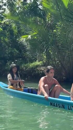 Four people travel by boat on Litik River, Philippines
