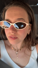 Woman in sunglasses filmed inside car in Milan
