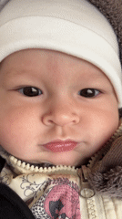 Baby in white beanie recorded in close-up video, Sochi