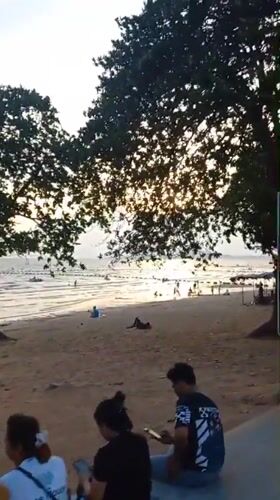 Beachgoers gather at Pattaya during sunny morning hours