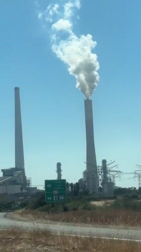Industrial smokestack emits white smoke in Hadera, Israel