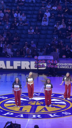 Dance troupe performs on basketball court in Los Angeles stadium