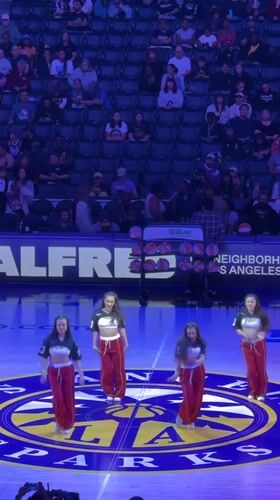 Dance troupe performs on basketball court in Los Angeles stadium