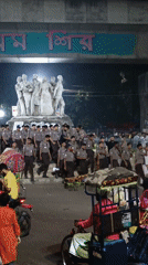 Evening crowds and rickshaws captured in central Dhaka
