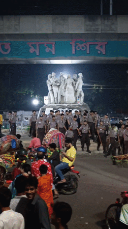 Evening crowds and rickshaws captured in central Dhaka