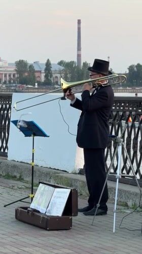 Trombone player performing on Izhevsk's waterfront promenade