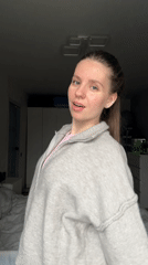Young woman documents herself dancing, posing in Klin bedroom