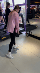 Man performs overhead barbell lift in Perm gym