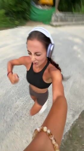 Woman films herself jogging on road in Chalong Thailand