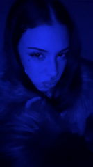 Woman with facial piercings photographed in blue light, Buenos Aires