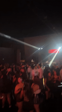 Late-night dancing crowd fills Arica nightclub with colorful lights