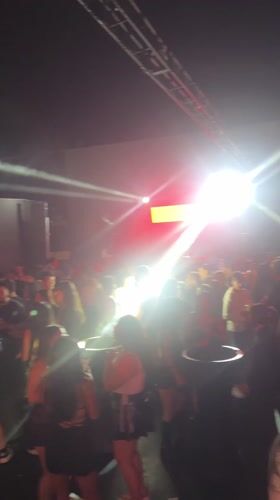 Late-night dancing crowd fills Arica nightclub with colorful lights