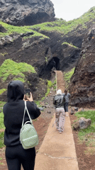 Tourists photograph coastal formations at Porto Moniz lava tubes
