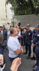 Civilian speaks with riot police on Caracas street