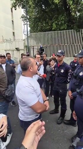 Civilian speaks with riot police on Caracas street