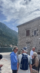 Tourists queue at historic Church of St. Nicholas in Perast