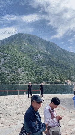 Tourists queue at historic Church of St. Nicholas in Perast