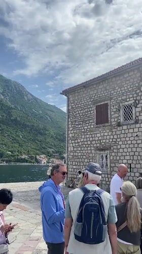 Tourists queue at historic Church of St. Nicholas in Perast