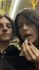 Two young people observed standing together on Buenos Aires bus