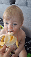 Toddler eating and playing indoors in Tula
