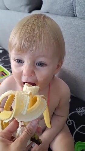 Toddler eating and playing indoors in Tula