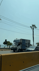 Traffic flows along palm-lined coastal road in Miraflores