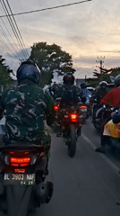 Military motorcyclists gather on road in Keudebayu, Indonesia