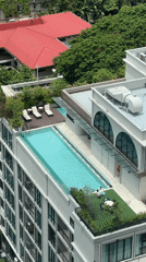 Rooftop pool with lounge chairs spotted in Bangkok
