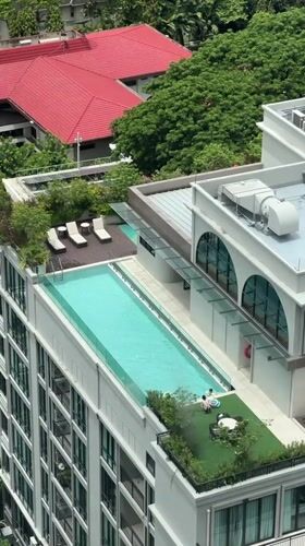 Rooftop pool with lounge chairs spotted in Bangkok