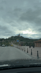 Vehicle approaches historic Tsarevets Fortress in Bulgaria under cloudy skies